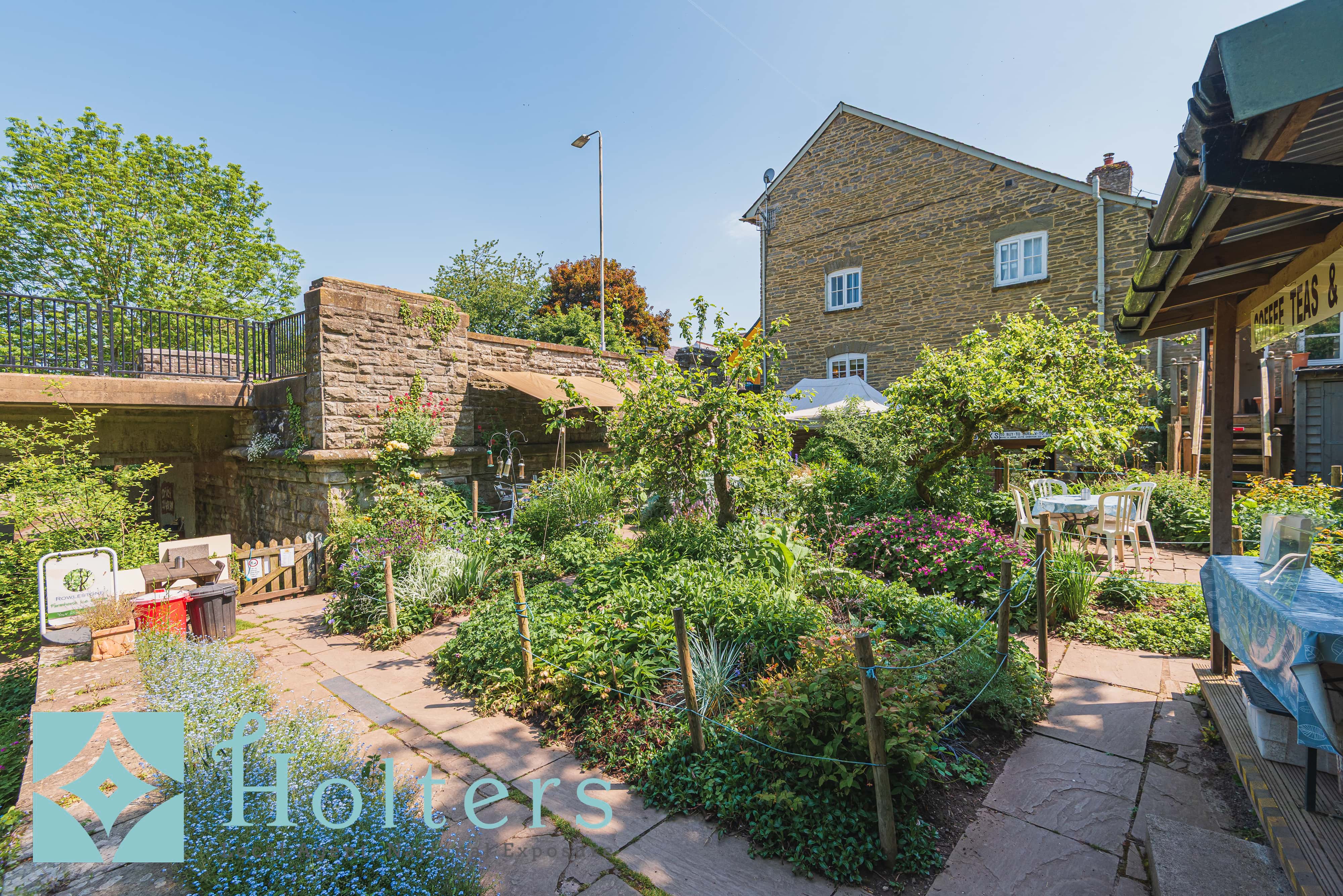 Lush garden with stone bridge arch